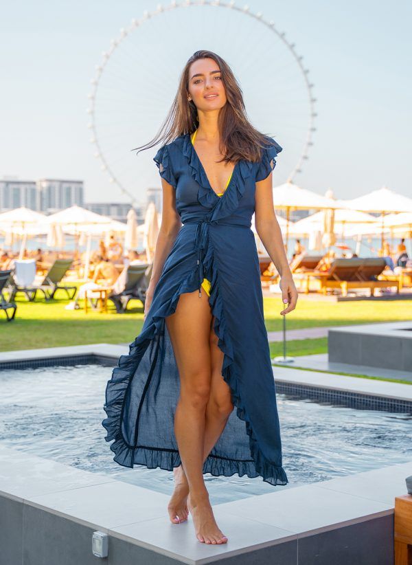 The Lizzie in navy is a maxi length wrap dress that is perfect for wearing over swimwear. Part of the CAHA CAPO resortwear collection.