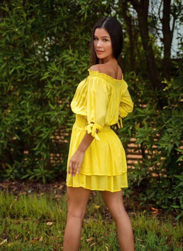 The Florence in yellow is a glamourous off-shoulder dress made in viscose dobby. Part of the CAHA CAPO women's resortwear collection.