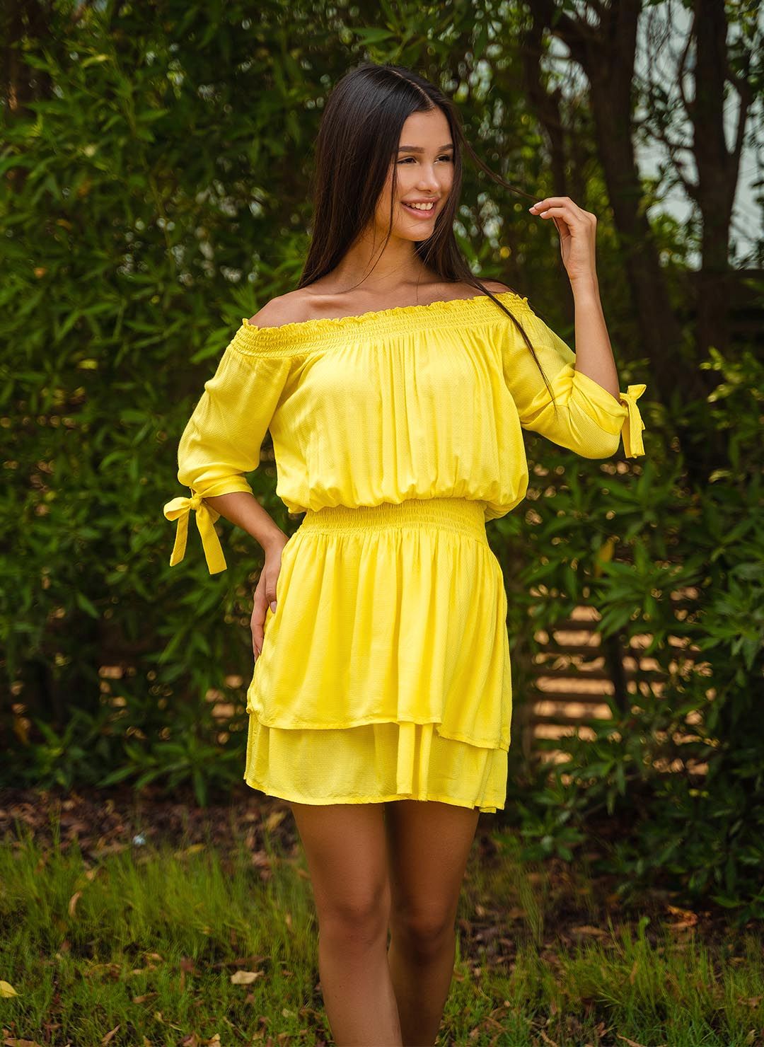 The Florence in yellow is a glamourous off-shoulder dress made in viscose dobby. Part of the CAHA CAPO women's resortwear collection.
