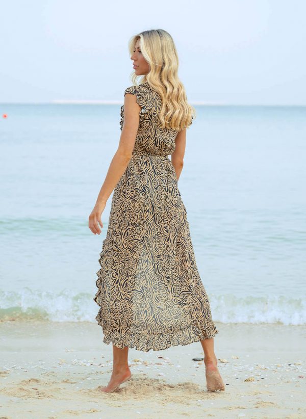 The Lizzie in Glamazonia is an embroidery maxi length wrap dress that is perfect for wearing over swimwear. Part of the CAHA CAPO resortwear collection.