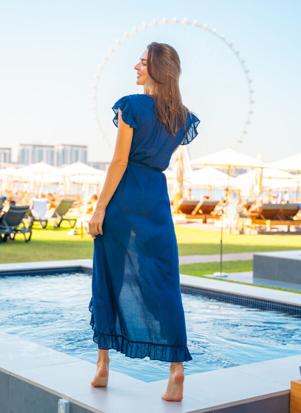 The Lizzie in navy is an embroidery maxi length wrap dress that is perfect for wearing over swimwear. Part of the CAHA CAPO resortwear collection.