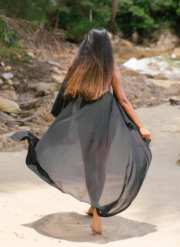 The Mim in black is a maxi throw-on kaftan made in lightweight fabric. Part of the CAHA CAPO women's resortwear collection.