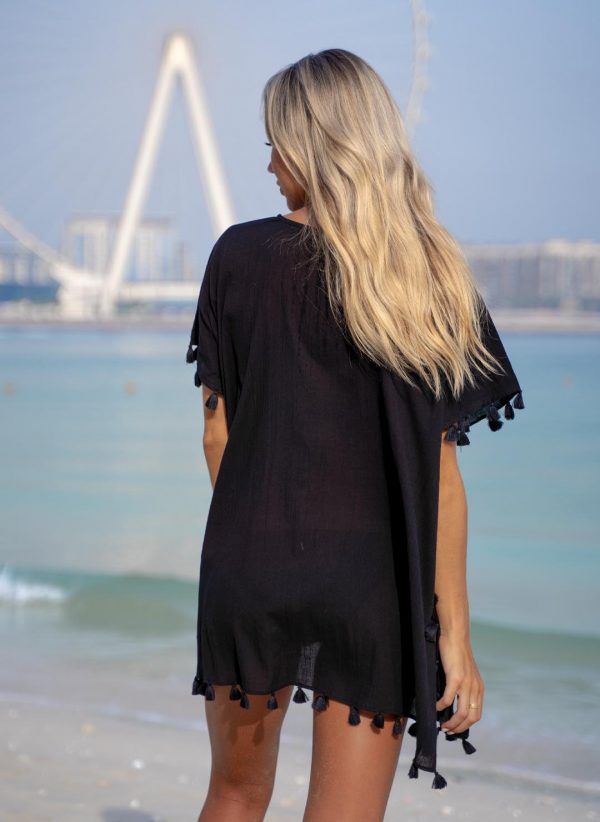 The Katherine kaftan is a black cotton kaftan with a V-neck and adjustable drawcord. Part of the CAHA CAPO resortwear collection.