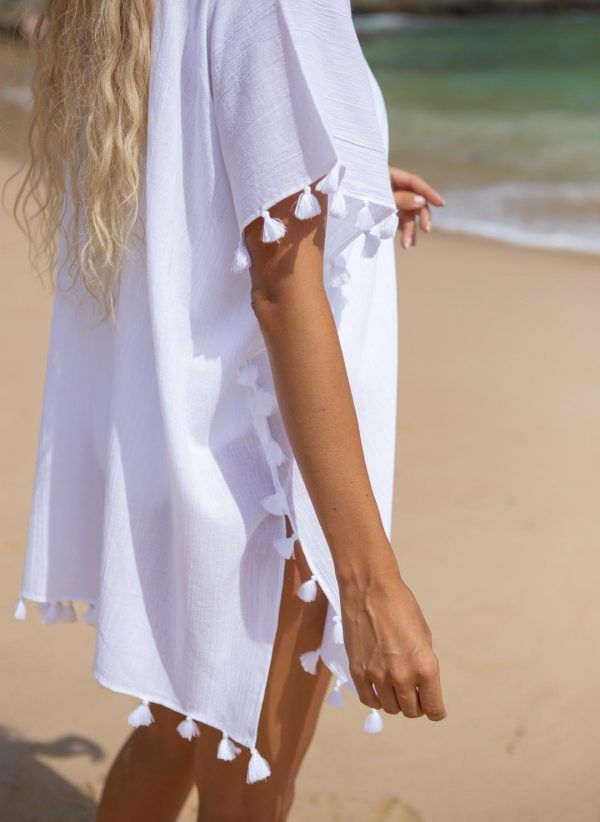 The Katherine kaftan is a white cotton kaftan with a V-neck and adjustable drawcord. Part of the CAHA CAPO resortwear collection.