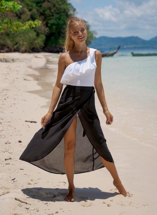 The Mia in black is a lightweight beach skirt with a wrap design and is made in viscose. Part of the CAHA CAPO women's resortwear collection.