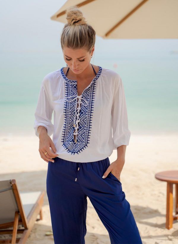 The Poppy shirt in white/navy is a casual women's shirt with embroidery. Part of the CAHA CAPO women's resortwear collection.